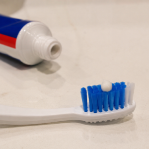 Cheap Toothpaste and smaller than a pea-sized amount of toothpaste on a toothbrush